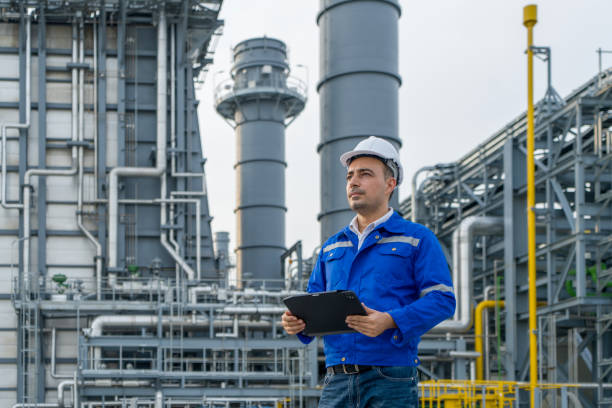 gettyimages-1497102572-612x612 Engineer with digital tablet working at petroleum oil refinery, and power plant.